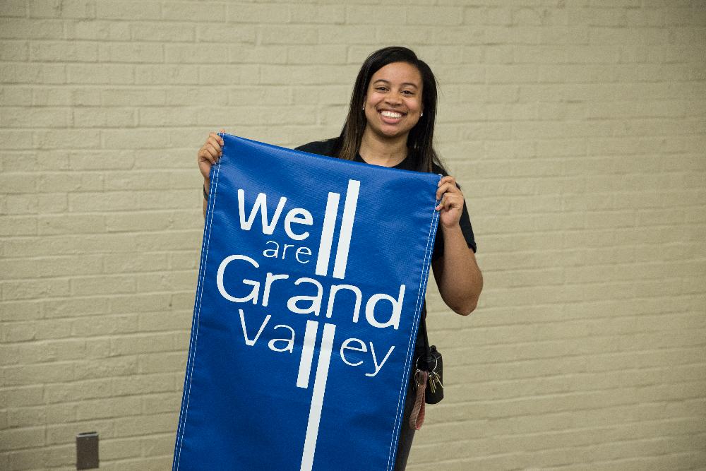 Girl holding "We are Grand Valley" banner